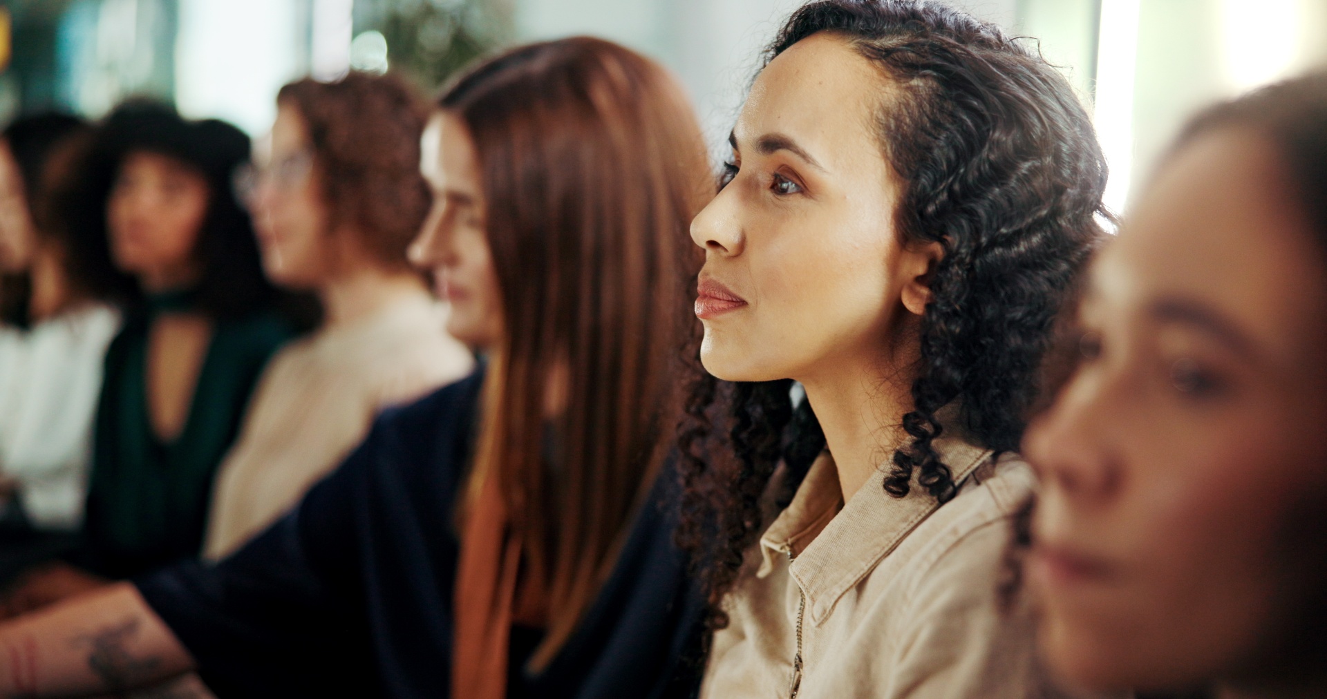 A close group of women sitting together in warm supportive conversation.